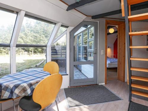 a room with a bed and chairs and a window at 7 person holiday home in Lemvig-By Traum in Trans