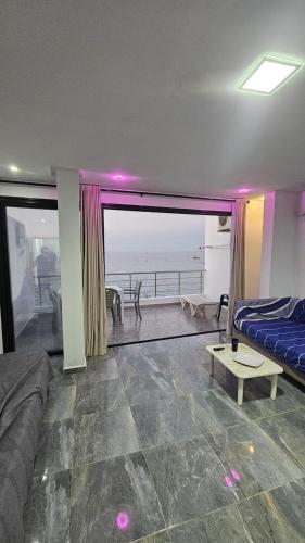 a living room with a bed and a view of the ocean at Dream View Luxe in Rafrāf