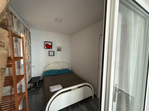 a small room with a bed and a window at Dream View Luxe in Rafrāf