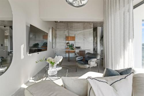 a living room with a white couch and chairs at Villa Sund in Uddevalla
