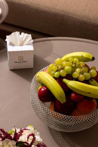 a bowl of fruit on a glass table at NearYo Hotels in Marrakech