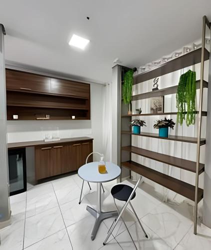 a kitchen with a table and chairs in a room at Loft Estilo seguro e bem localizado in Rio Branco