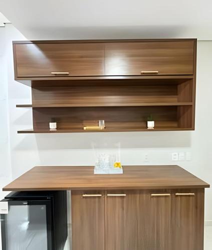 a kitchen with a wooden counter top and a microwave at Loft Estilo seguro e bem localizado in Rio Branco
