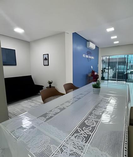 a conference room with a glass table in the middle at Loft Estilo seguro e bem localizado in Rio Branco