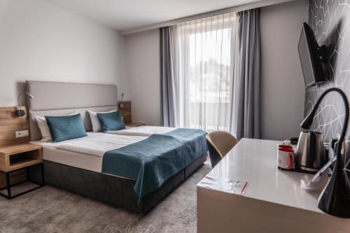 Una cama o camas en una habitación de Hotel Limanova
