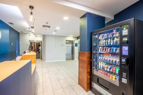 a soda machine in a store with a drink cooler at Travelodge Murcia in Murcia