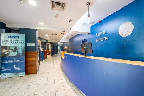 a lobby of a hospital with a blue wall at Travelodge Murcia in Murcia