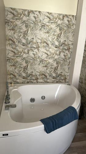 a white bath tub with a towel in a bathroom at Villa Blue Paradise Relax con piscina a pochi minuti da Cagliari e dal mare in Cagliari