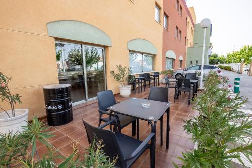 a patio with tables and chairs outside of a building at Travelodge Murcia in Murcia