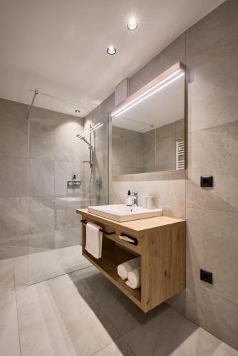 a bathroom with a sink and a mirror at Hotel Schmuckhof in Chiusa