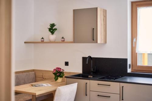 a kitchen with a table and a counter top at Hotel Schmuckhof in Chiusa