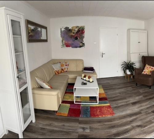 a living room with a couch and a coffee table at Ferienwohnung an der Schelde in Dillenburg