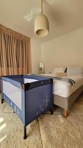 a bedroom with a blue bed in a room at Dar Hegoa Villa Soleil et Chaleureuse in Marrakech