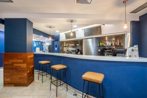 a blue bar in a restaurant with stools at Travelodge Murcia in Murcia