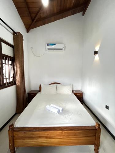 a bedroom with a bed with a towel on it at Two Bedroom Villa Tangalle in Tangalle