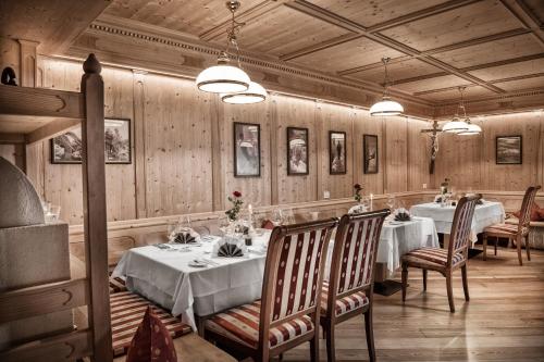 a dining room with two tables and two chairs at FAYN garden retreat hotel in Lagundo