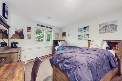 a bedroom with a bed and a desk at Slopeside A2 in Stratton