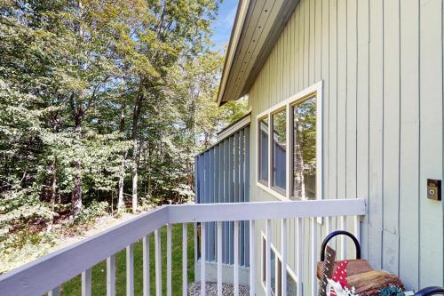 a house with a white railing on a porch at Slopeside A2 in Stratton