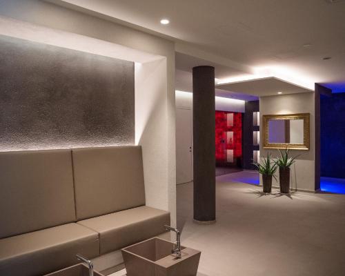a lobby with a couch and a chalkboard on the wall at FAYN garden retreat hotel in Lagundo