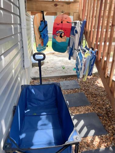 a blue umbrella sitting on the side of a house at Seaberry Hideaway, A Modern 2BR Apt 3miles to Bethany Beach in Ocean View
