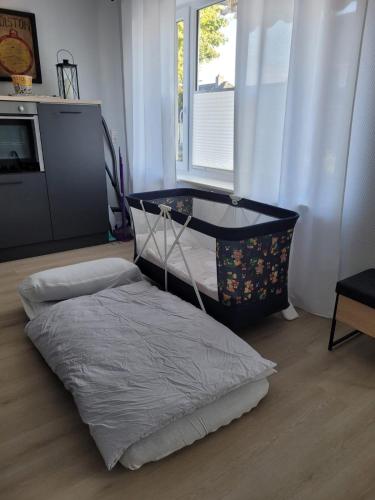 a bedroom with a bed and a tv and a window at Heide Smile, Apartment in Schneverdingen