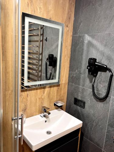 a bathroom with a sink and a mirror at GomuL in Vorokhta