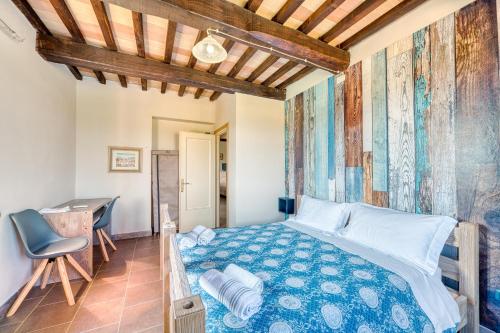 a bedroom with a bed and a desk at Casale Rialto in Montefalco