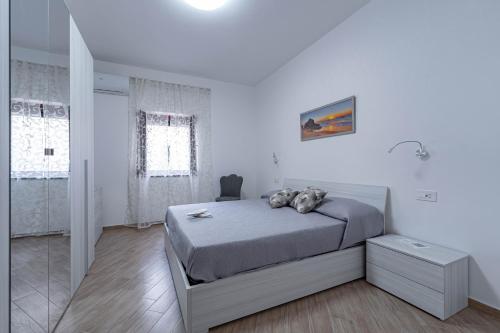 a bedroom with a bed in a white room at A casa dei nonni in Scala