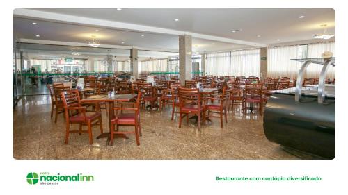 a dining room with wooden tables and chairs at Hotel Nacional Inn São Carlos & Convenções in São Carlos