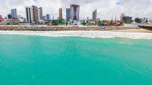 a body of water with a city in the background at ibis Styles Fortaleza Shopping Giga Mall in Fortaleza