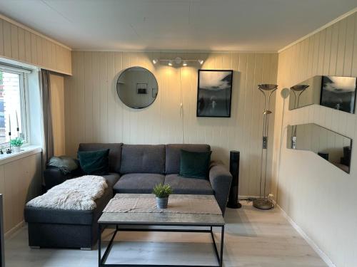a living room with a couch and a table at Cozy apartment close to the city center and mountains in Tromsø