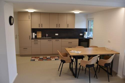 a kitchen with a wooden table and chairs at Gästehaus in Thüringen in Thüringen