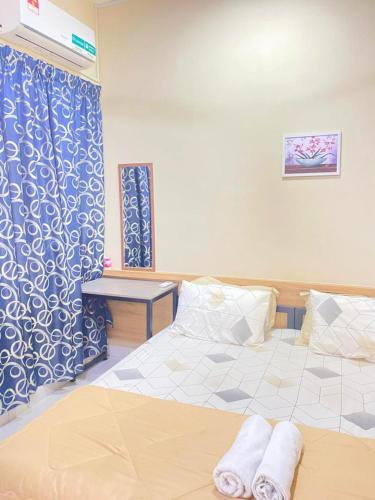 a bedroom with a bed with two towels on it at 2 Bedrooms Suites at Mesahill Nilai with Mall by D'KAY HOMES, near USIM KLIA in Nilai