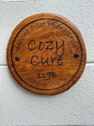 a wooden sign on a wall that says curry give life at Cozy Cure Apartment in Downtown and Historic Pilot Mountain in Pilot Mountain