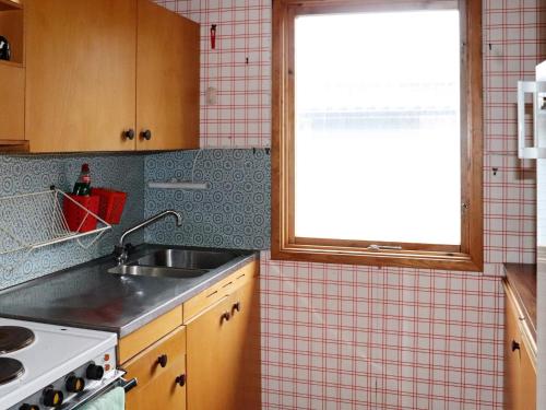 a kitchen with a sink and a window at 4 person holiday home in Heberg in Heberg