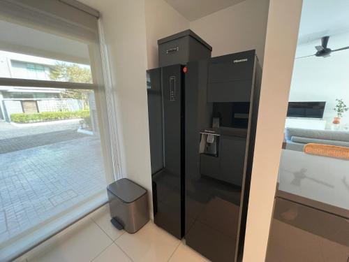 a black refrigerator in a room with a window at Malibu 2BR Villa - Private Pool Langkawi in Pulau Tepur