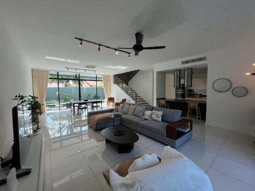 a living room with a couch and a table at Malibu 2BR Villa - Private Pool Langkawi in Pulau Tepur