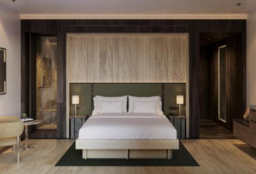 a bedroom with a large white bed in a room at Aethos Monterosa in Champoluc