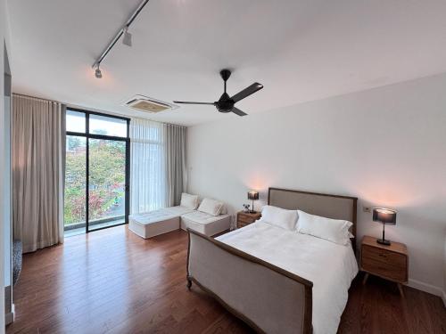 a bedroom with a bed and a ceiling fan at Malibu 2BR Villa - Private Pool Langkawi in Pulau Tepur
