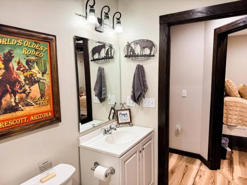 ein Badezimmer mit Waschbecken, Toilette und Spiegel in der Unterkunft Little River Retreat~Peaceful Countryside Getaway in De Queen
