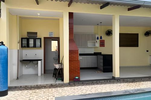 a kitchen and dining area of a house at Casa com piscina 03 quartos até 10 pessoas in Rio Branco