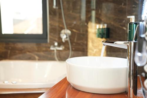 a white bowl on a counter in a bathroom at La Suite Boutique Hotel in Tirana