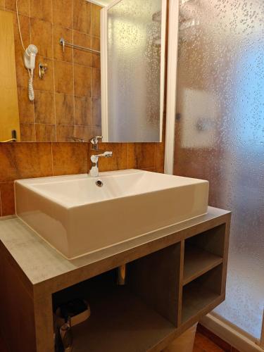 a white sink in a bathroom with a shower at Residence Les Coupoles in Champoluc