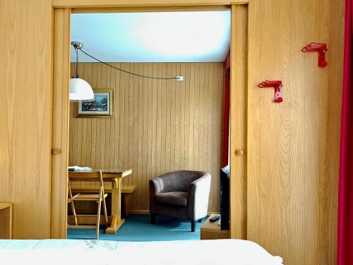 a bedroom with a desk and a chair and a table at Residence Les Coupoles in Champoluc