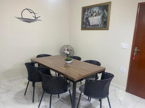 a wooden table and chairs in a room at Neusa Possar in Sao Paulo