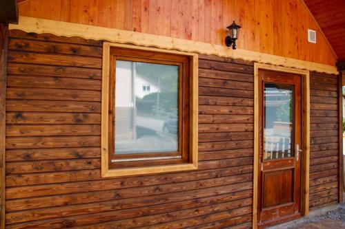 a wooden wall with a window and a door at Riverhouse in Kandern