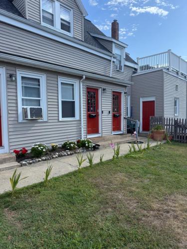 a house with red doors and flowers in the yard at Stylish Stay By Beach And Shops in Beverly
