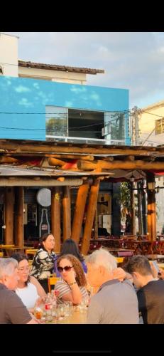 a group of people sitting at a table at Hostel do Meio in Salvador