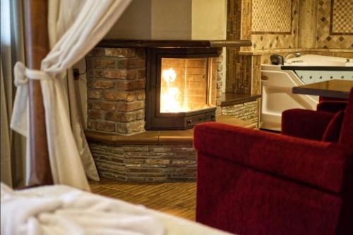 a brick oven with a fire in it in a room at Hotel Παραδοσιακό in Kato Loutraki
