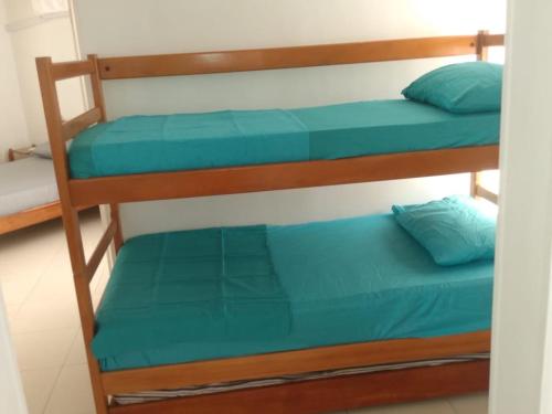 a couple of bunk beds with blue pillows on them at APARTAMENTO RODADERO MAR ARRECIFES In in Rodadero